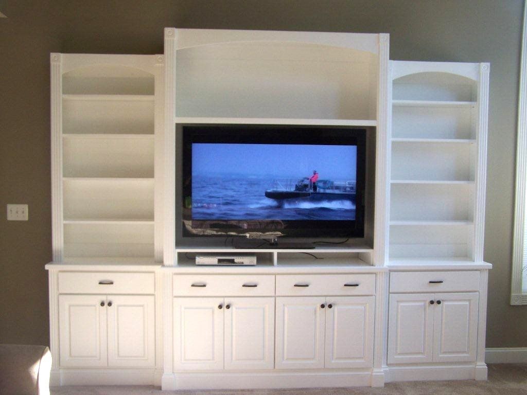 A white entertainment center with a flat screen tv