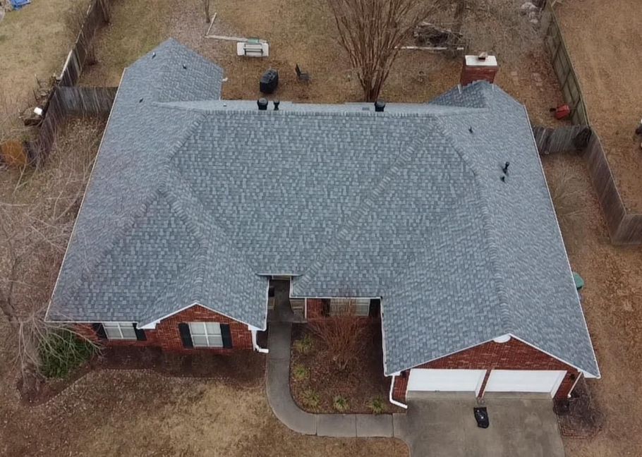 an aerial view of a brick house with a new roof .