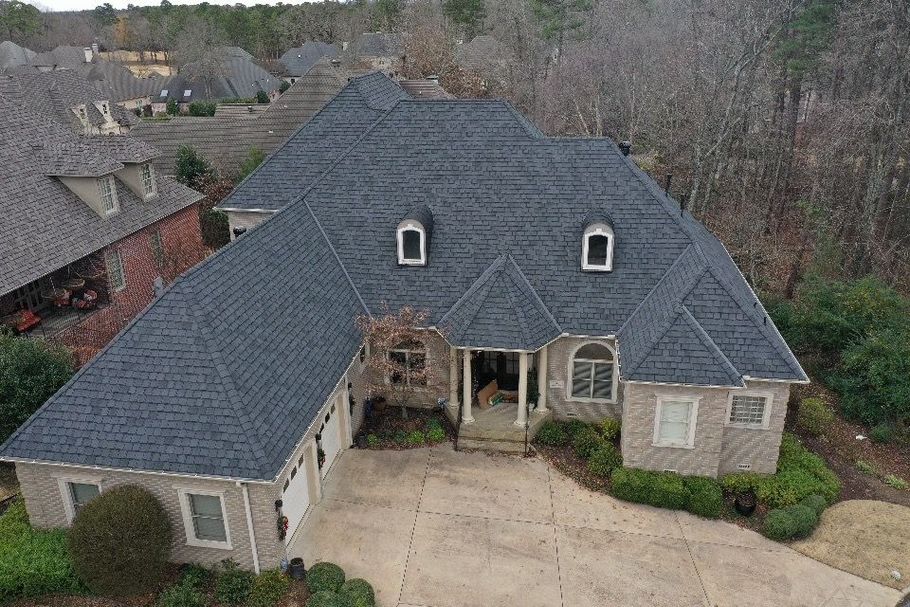 an aerial view of a large house with a blue roof .