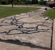 Man Spreading Asphalt - Granbury, TX - All-Star Coatings LLC