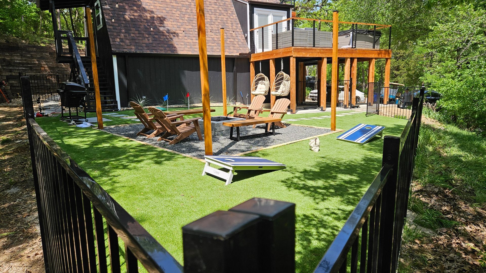 A backyard with a fence surrounding it and a house in the background.