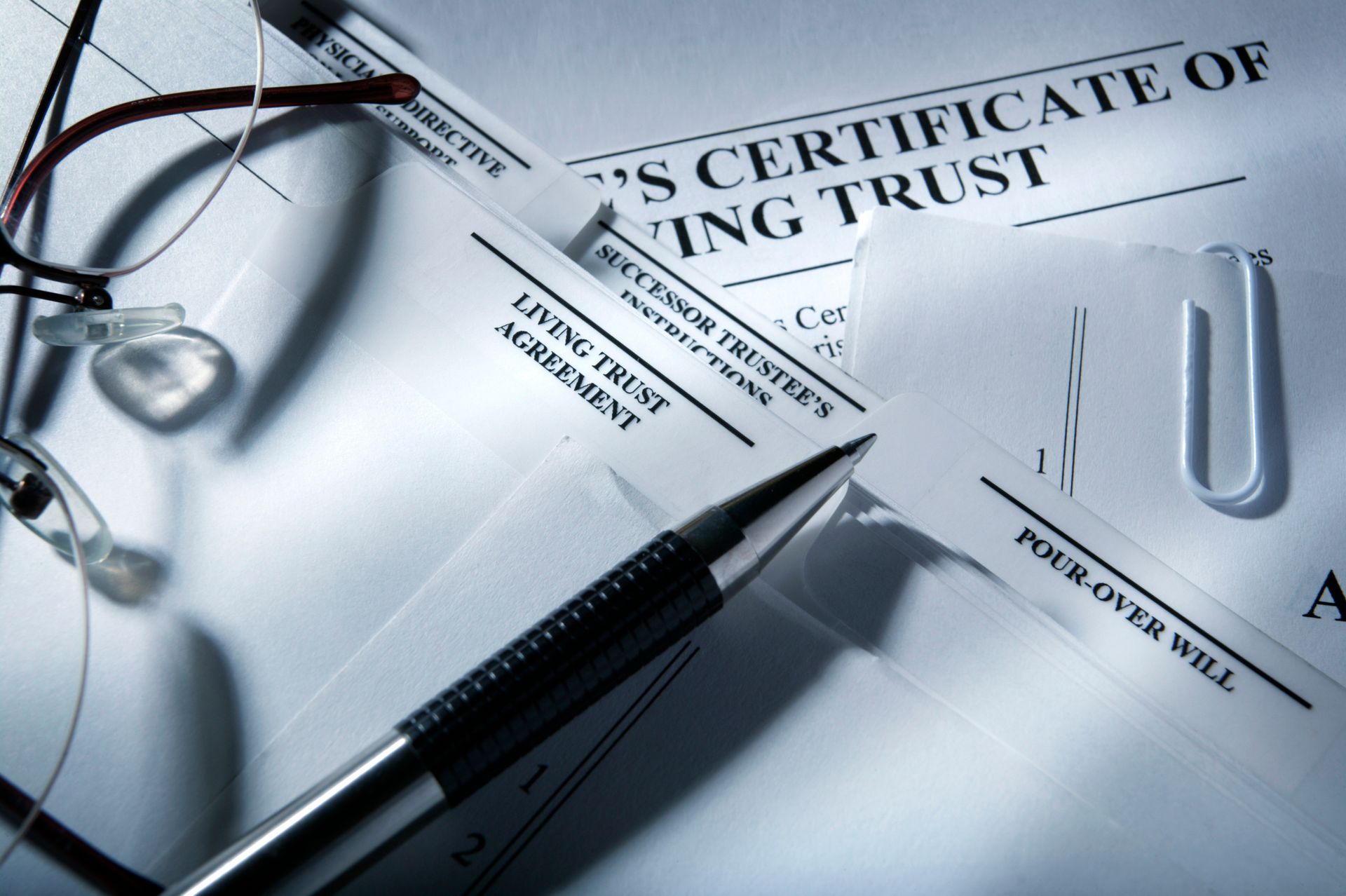 A pen rests on top of a certificate of living trust