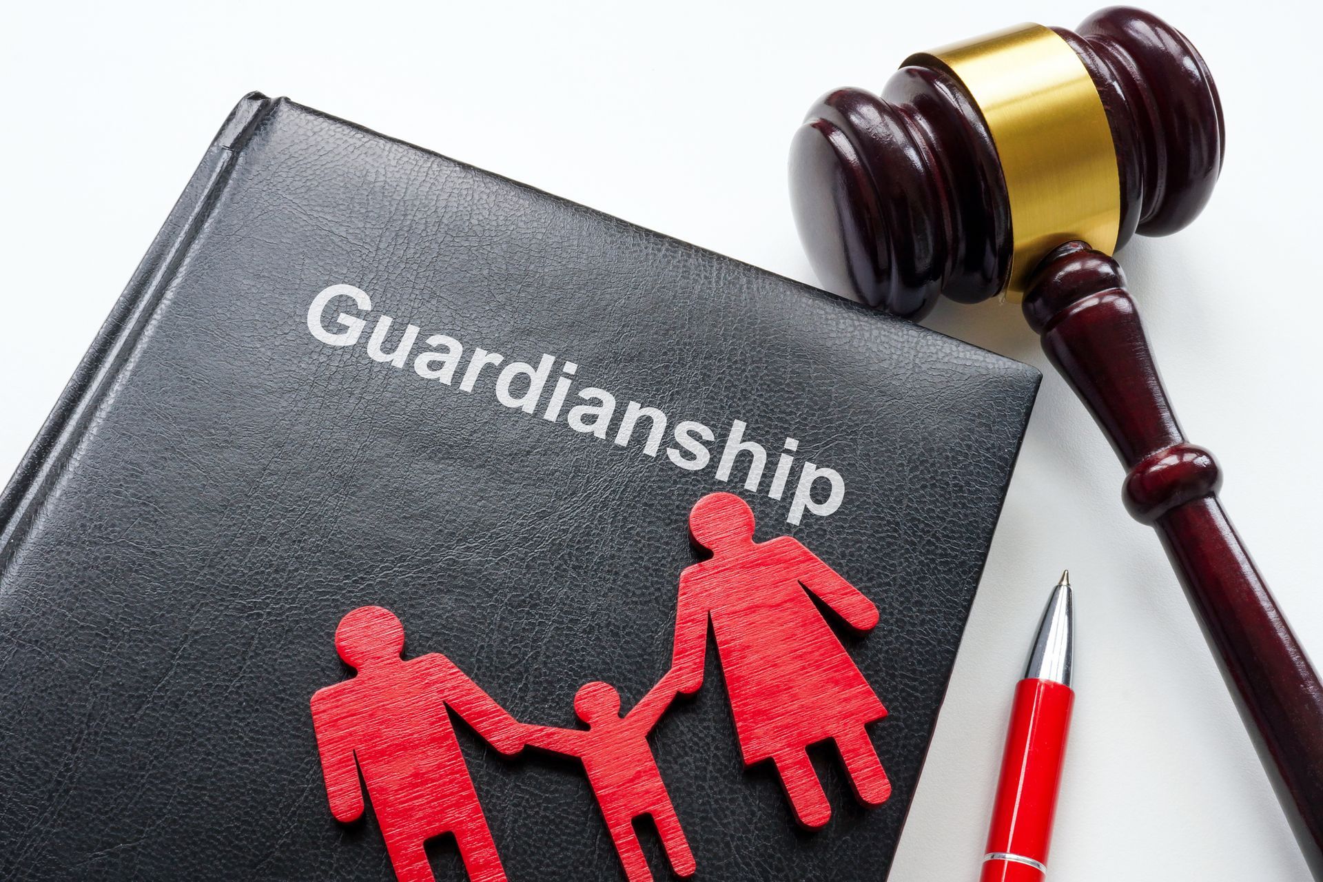 A book titled guardianship is next to a judge 's gavel and a pen.