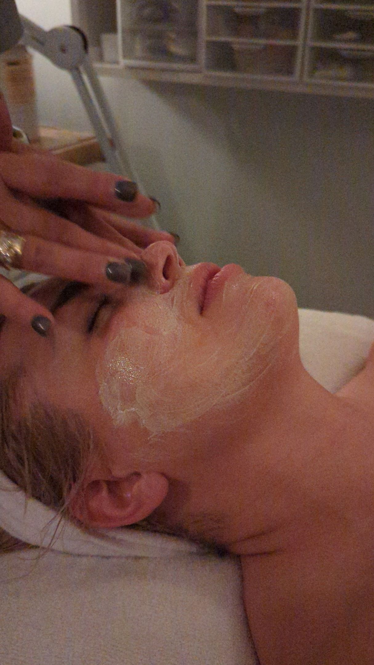 A woman is getting a facial treatment at New Eden Spa.