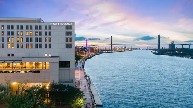 An aerial view of a large building next to a body of water.