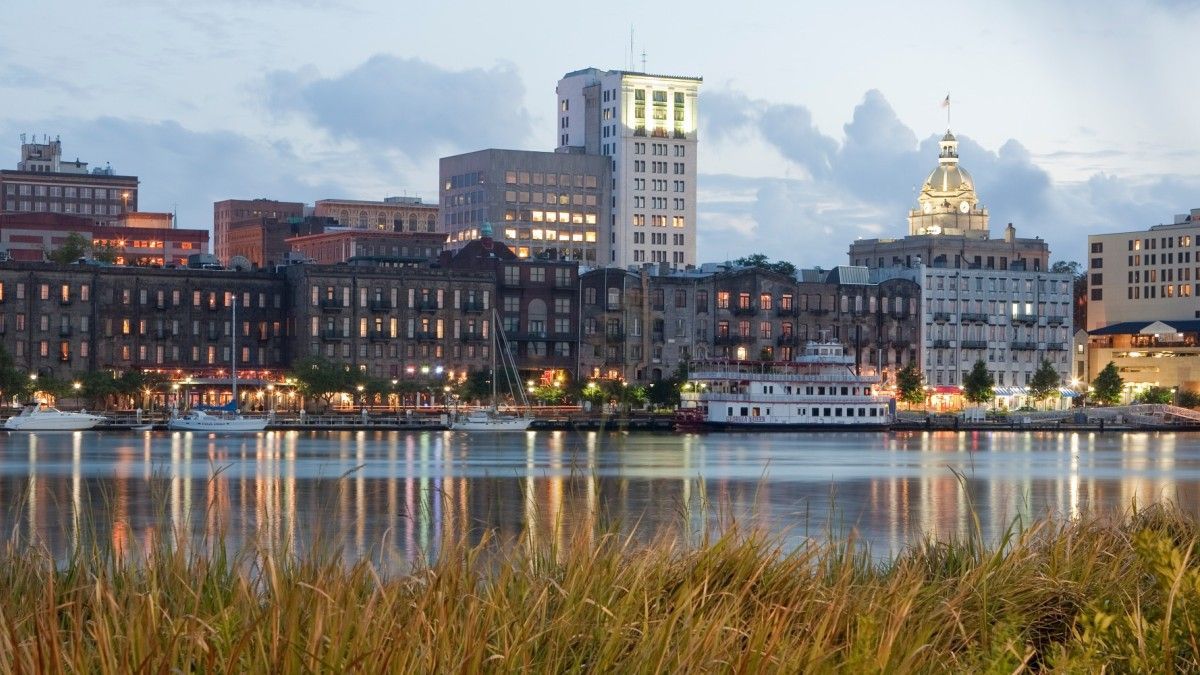 A city skyline with a body of water in the foreground.