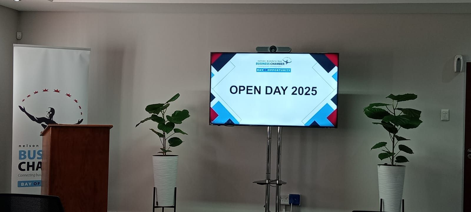 A room with a screen displaying 