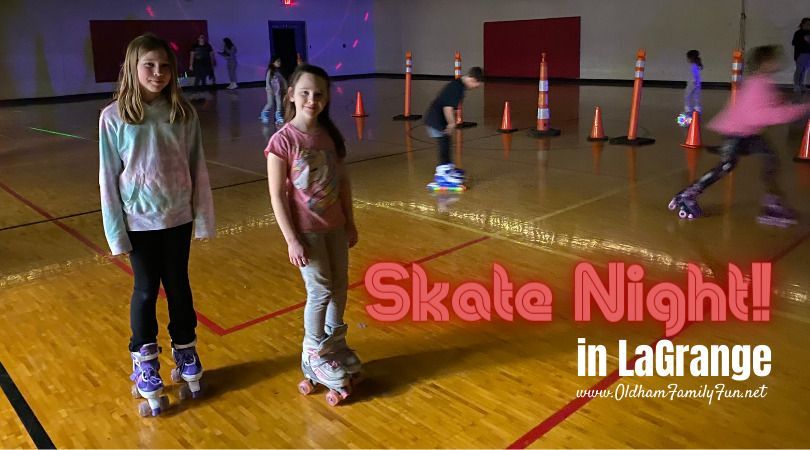 Two young girls are rollerblading on a roller rink.