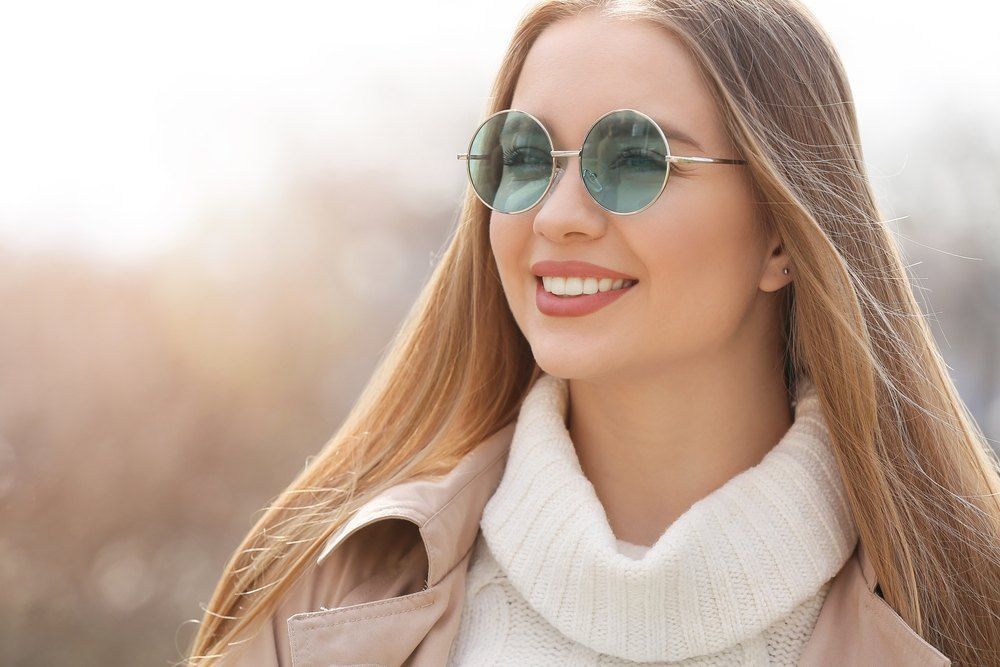 Woman With Long Blonde Hair, Wearing Round Sunglasses — Russell Cooper Optometrist In Rockhampton QLD