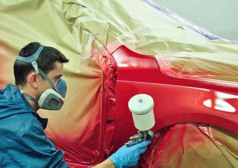 Auto body expert repainting the auto body — Port Allen, LA — Delaune’s Auto Body