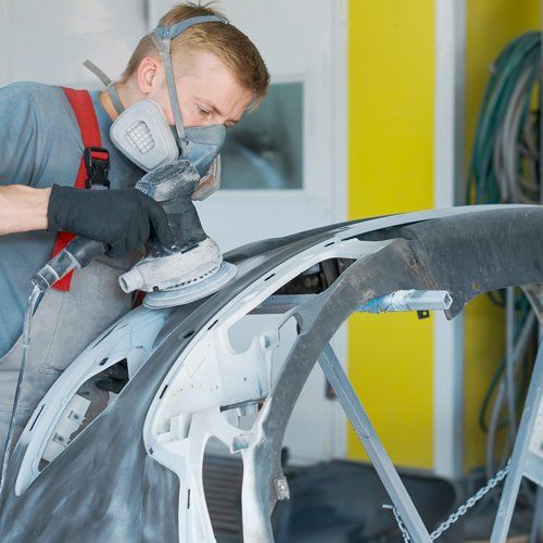 Auto body expert repairing a car damaged body part — Port Allen, LA — Delaune’s Auto Body