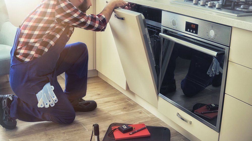 Service Man Fixing Dishwasher Machine — Modesto, CA — CVM Appliance