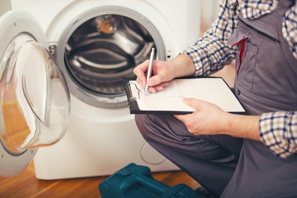 Repairman Is Repairing A Washing Machine — Modesto, CA — CVM Appliance
