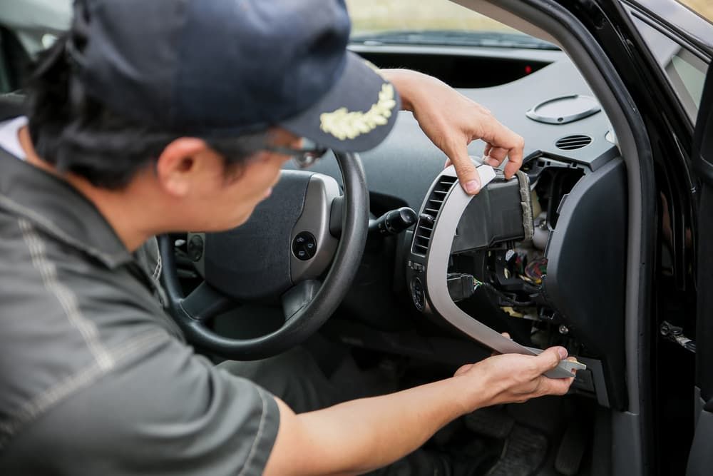 A Man is Working on the Dashboard of a Car — Mt Isa Four Wheel Drive Services in Mount Isa City, QLD
