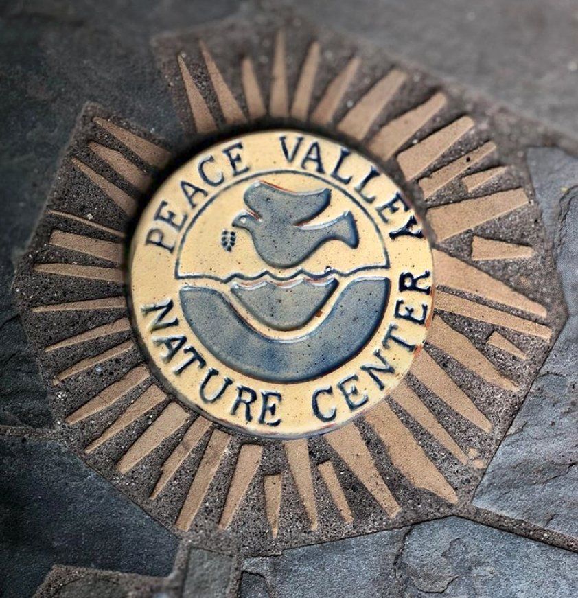 A peace valley nature center logo on the ground