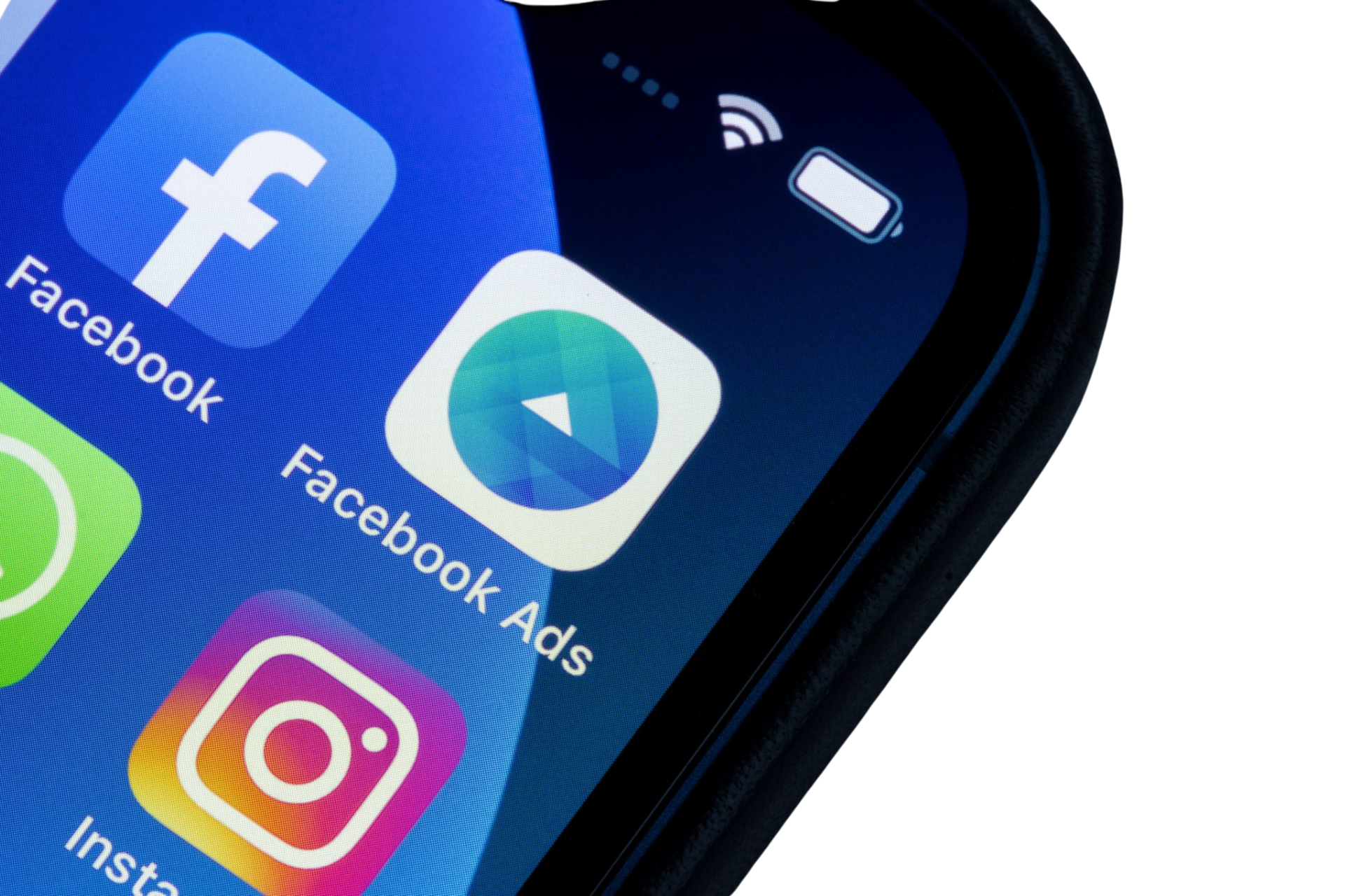 A close up of a cell phone with the facebook app on it