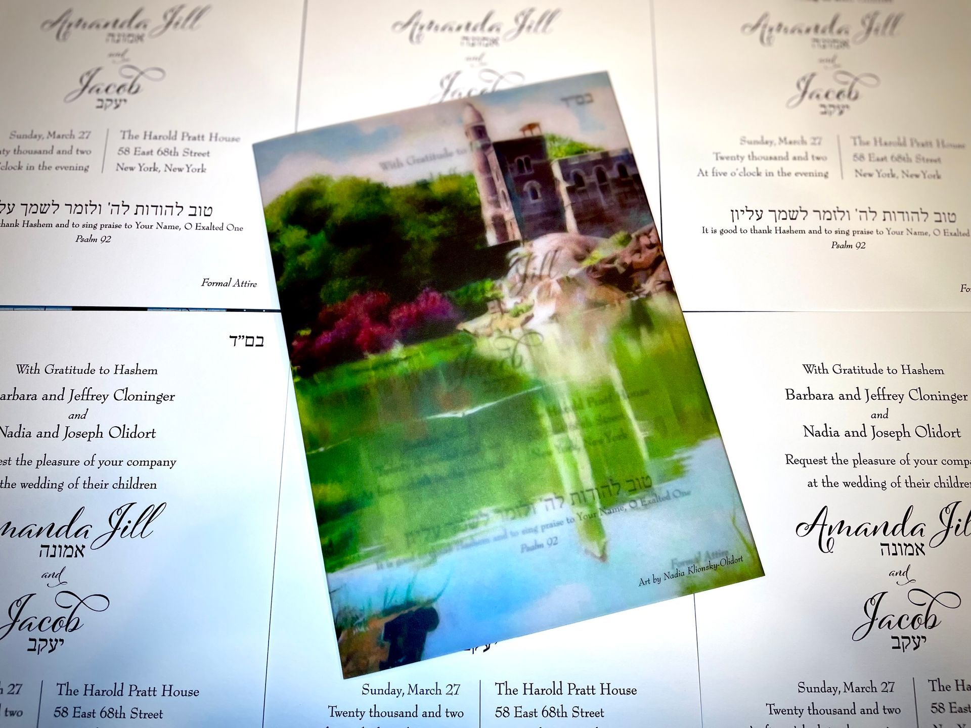 a wedding invitation for amanda jill and jacob with a custom oil painting of central park in new york done by the groom's mother made into a vellum wrap to hold the invitation