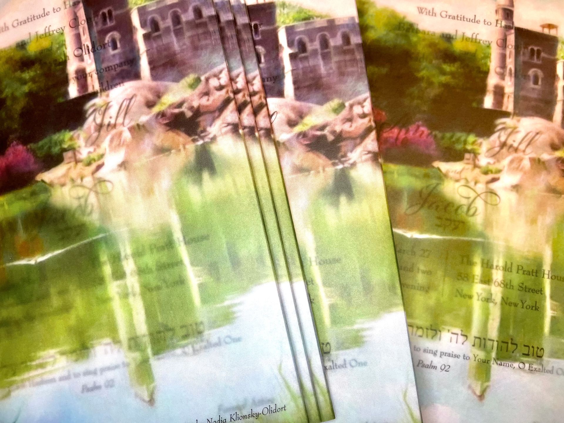 a custom oil painting of central park in new york done by the groom's mother made into a vellum wrap to hold the invitation