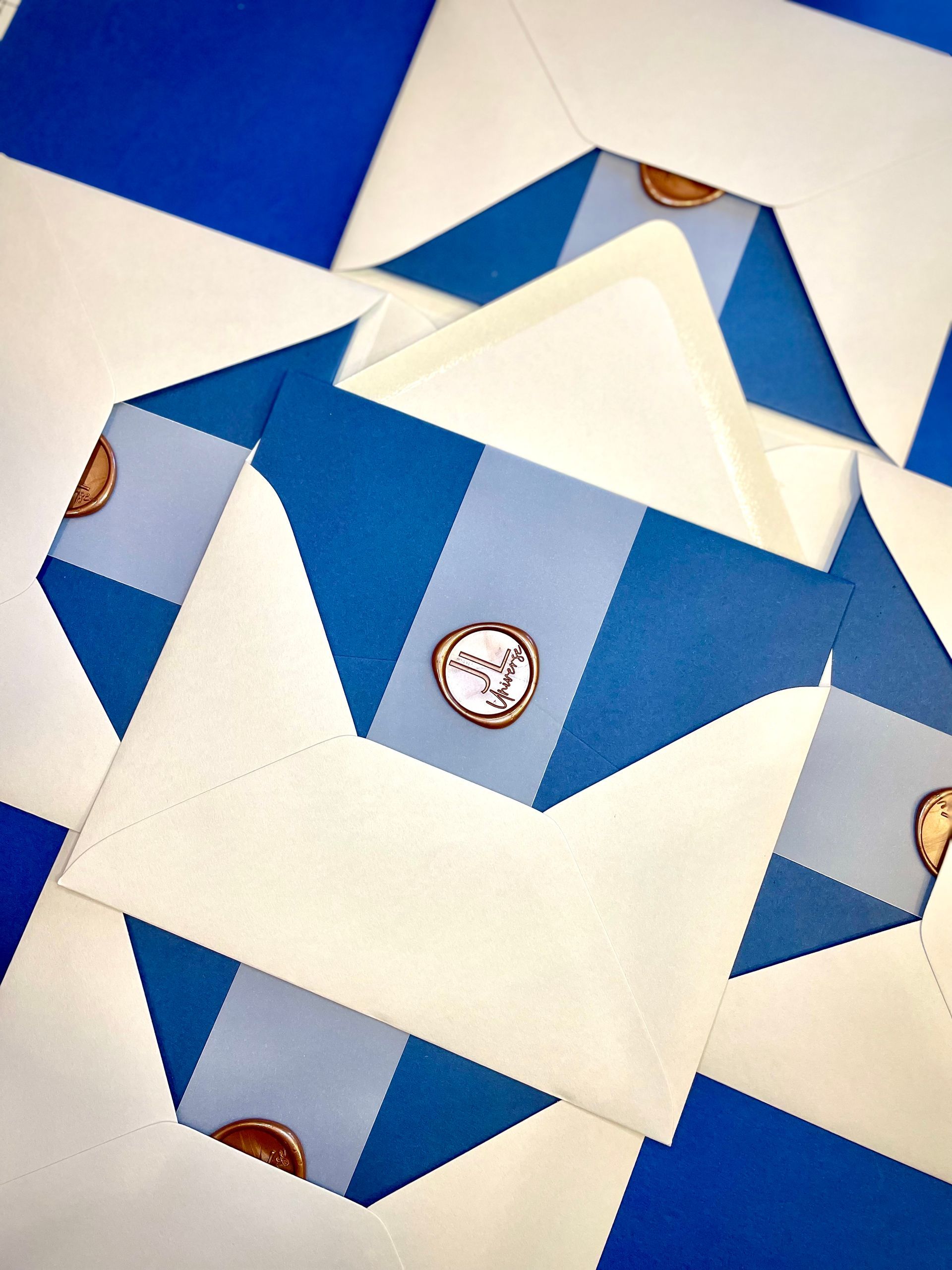 a blue and white striped envelope with a wax seal on it