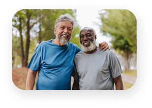Two older men are standing next to each other in a park.