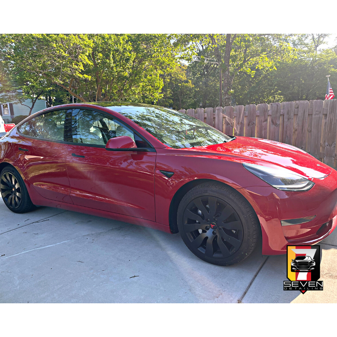 A red sedan detailed by a mobile detailing company.