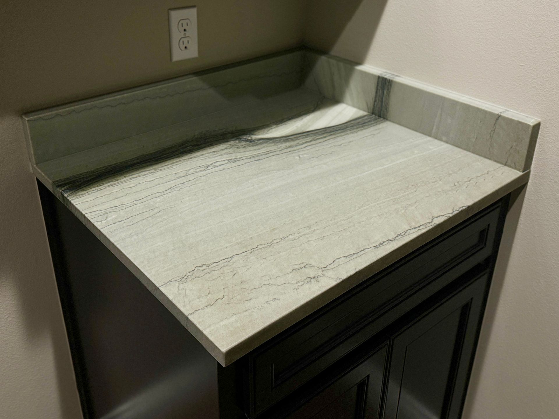 A counter top with a sink on it in a kitchen.