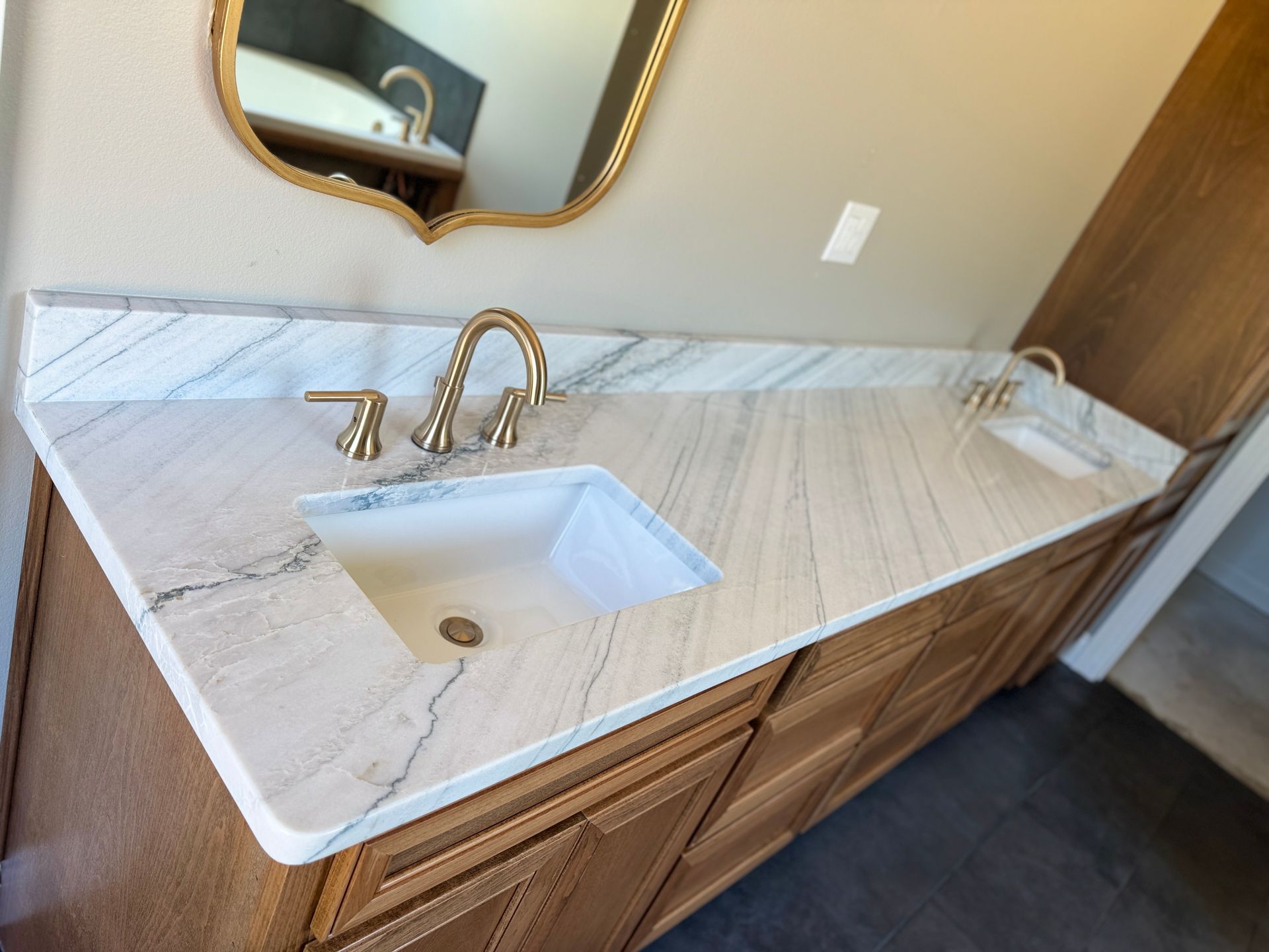 A bathroom vanity with a sink and a mirror.