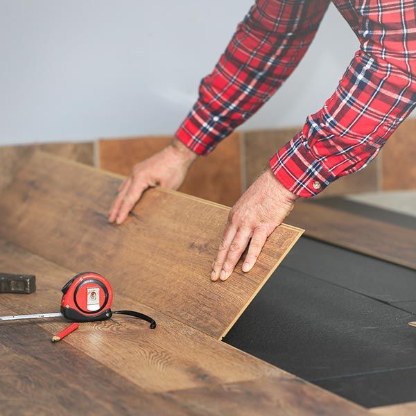 Worker Installing Laminate Floor — Wentzville, MO — Flooring Correct