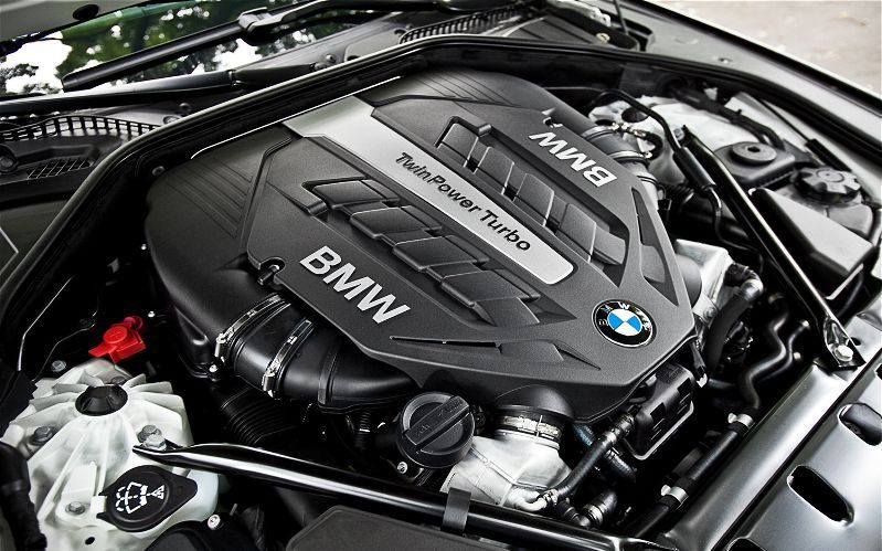 A close up of a bmw engine with the hood open