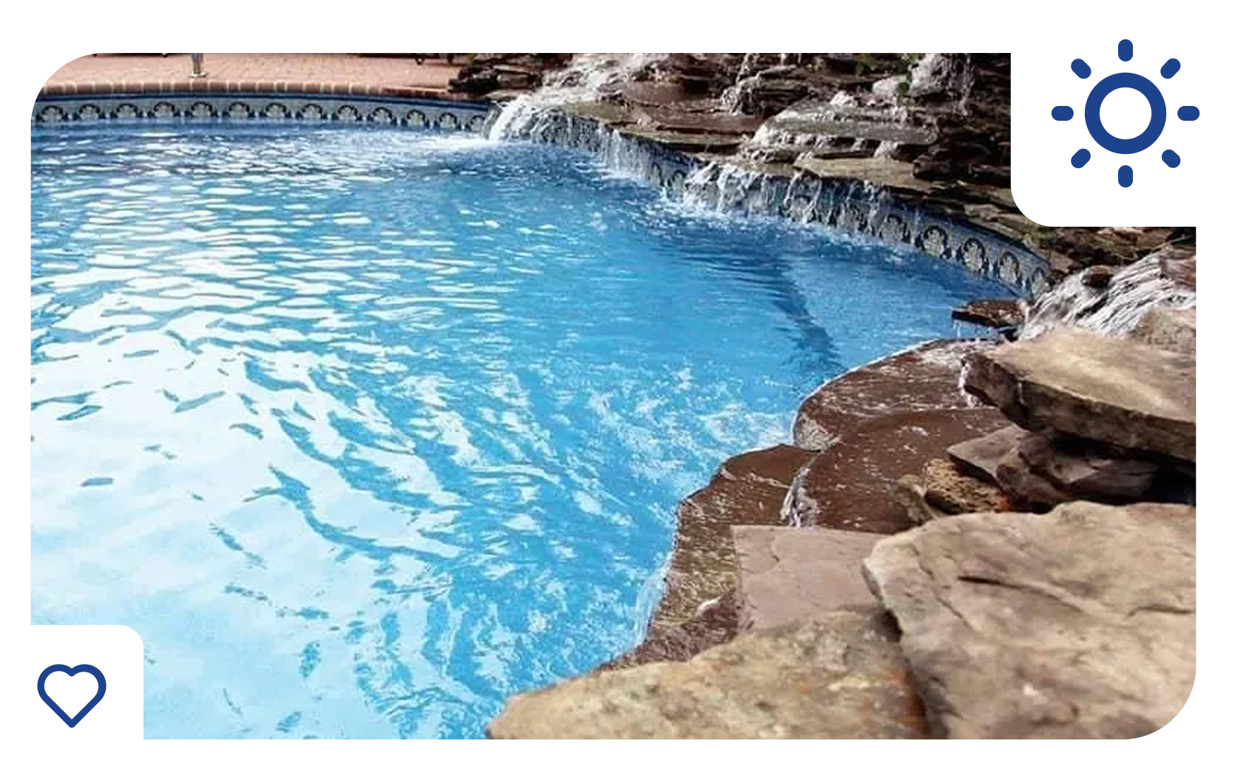 Swimming pool with a waterfall feature; blue water, sunny day.