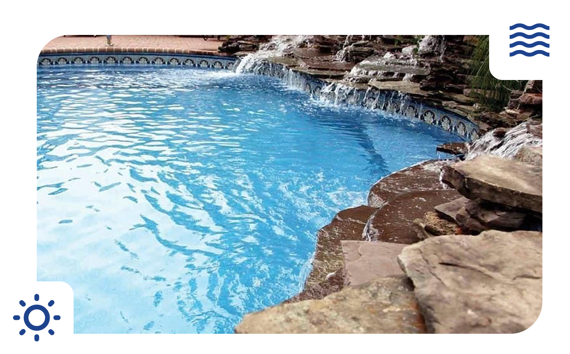 Pool with waterfall feature and blue water, surrounded by rocks.