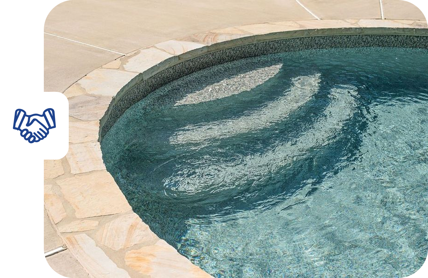 Swimming pool with steps, surrounded by stone.