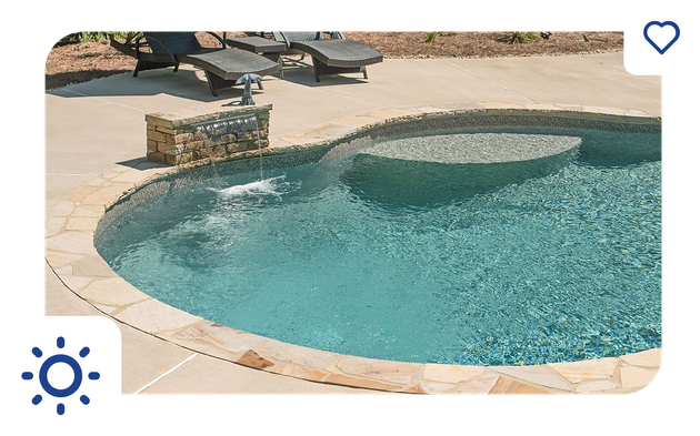 Modern white house with a pool, illuminated by lights, with a green lawn.