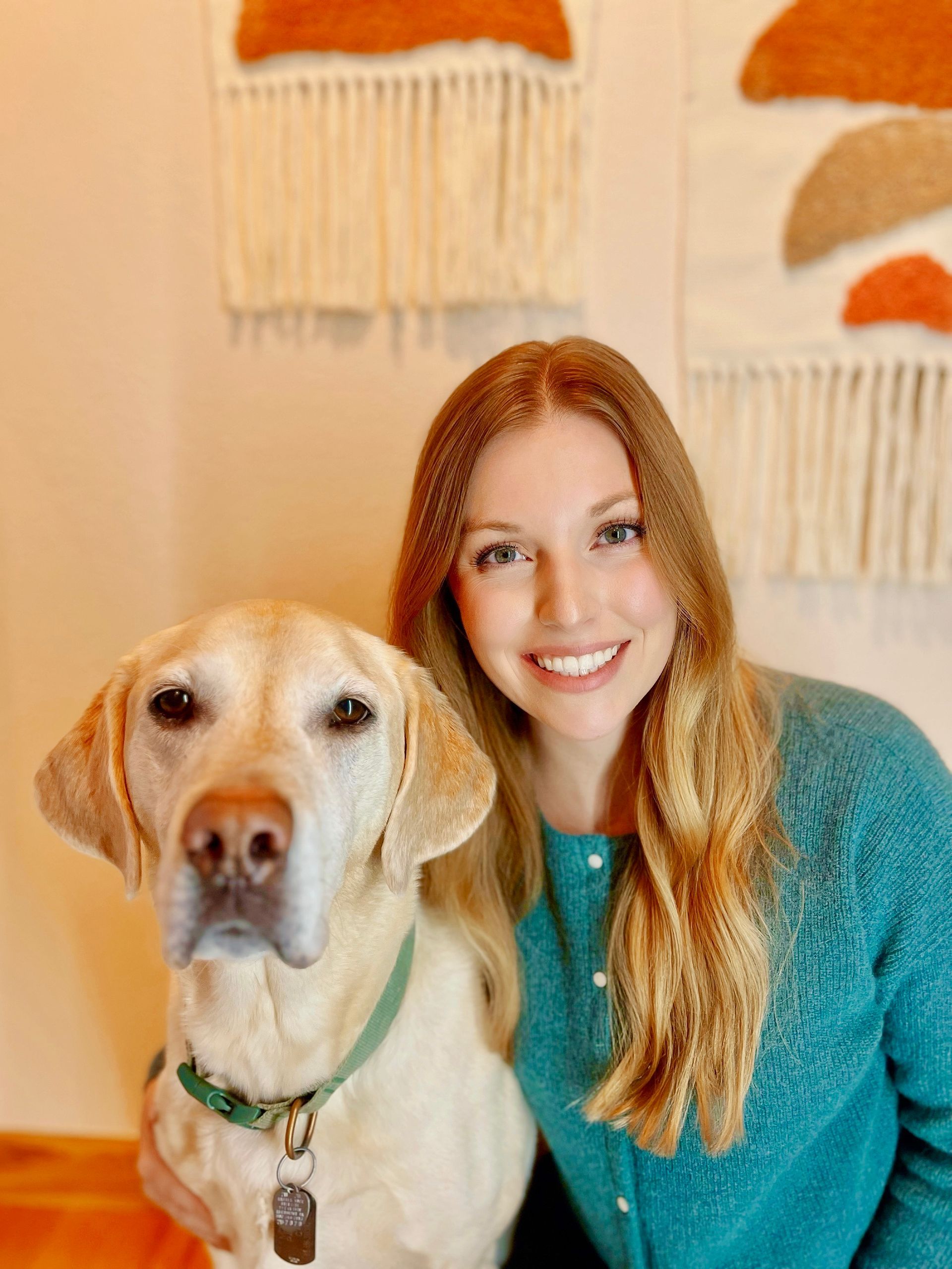 A woman is posing for a picture with her dog.
