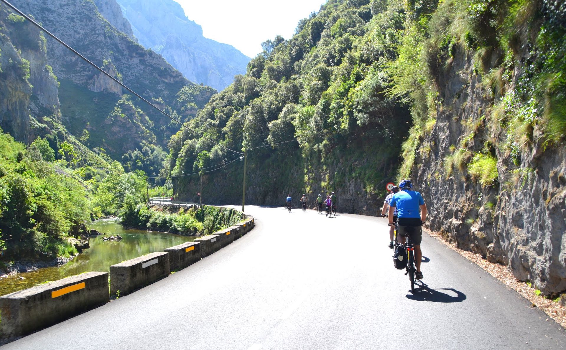 Cyclists riding on a tamac road in the Beyos Gorge, Asturias, Spain