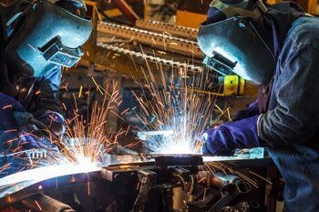 Two Welders Using The Welding Machine — Agricultural Supplies in Hanford, CA