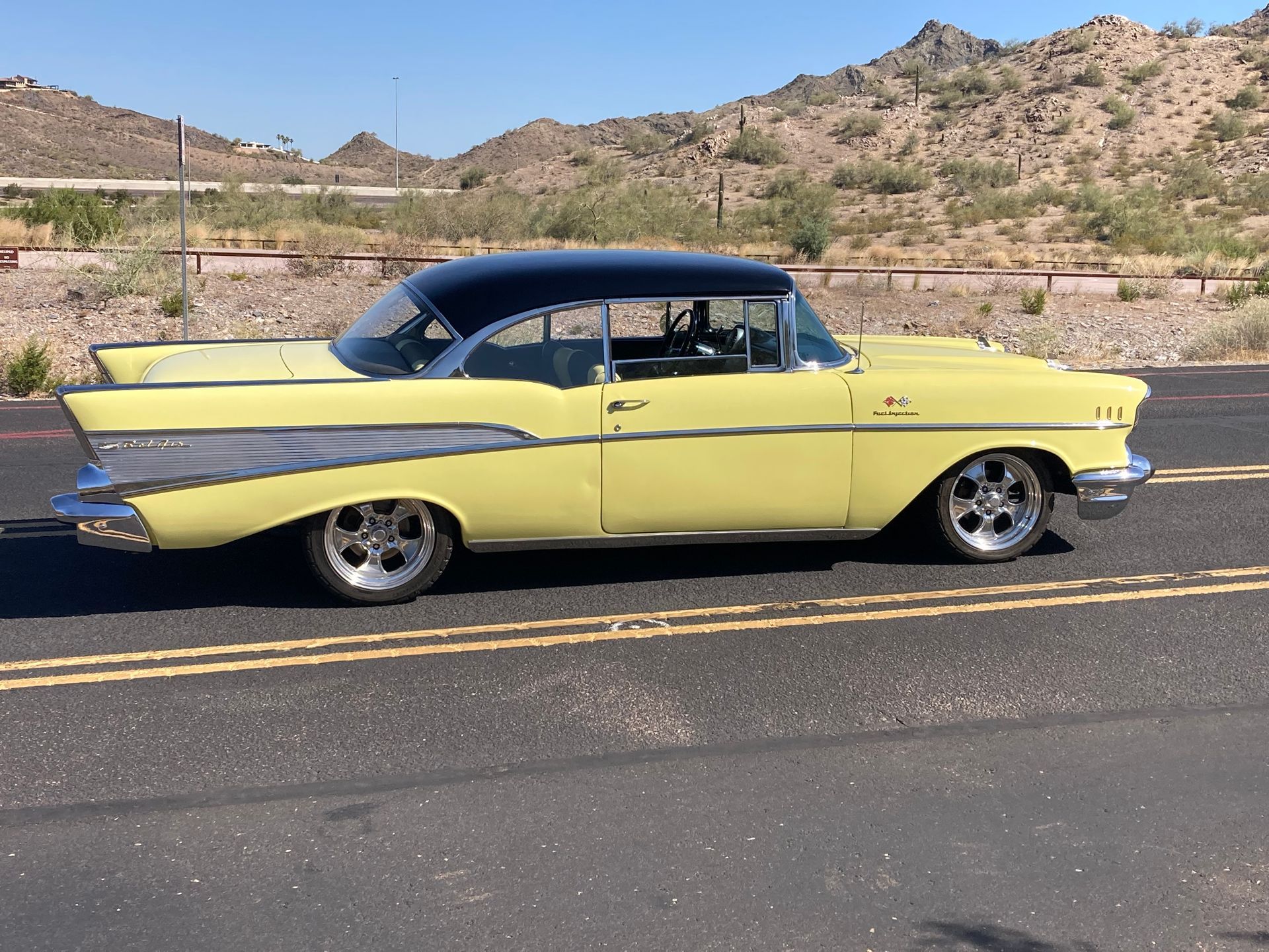 A yellow car is parked on the side of the road