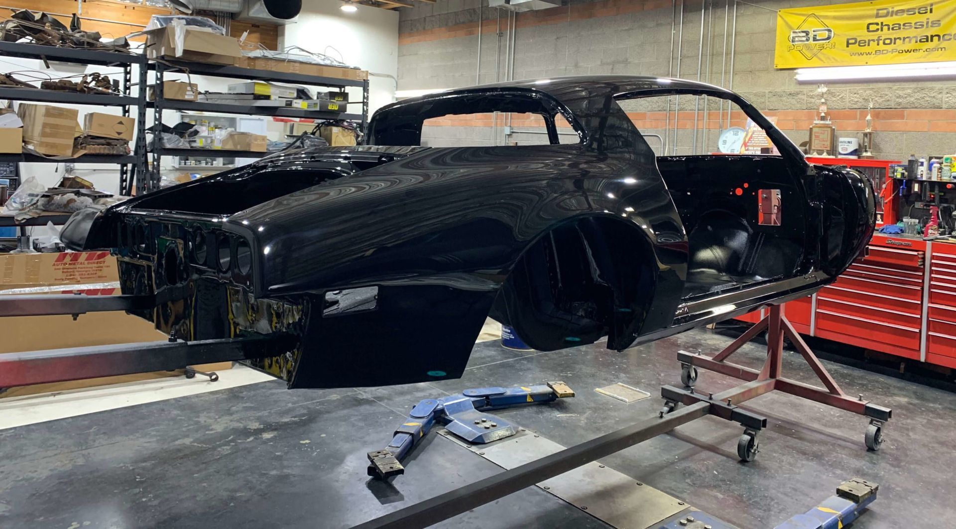 a black car is being built in a garage .