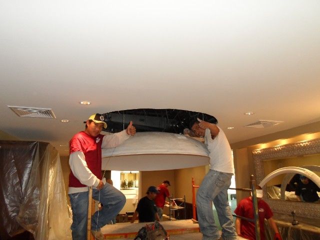 Professional Workers Installing Ceiling Design