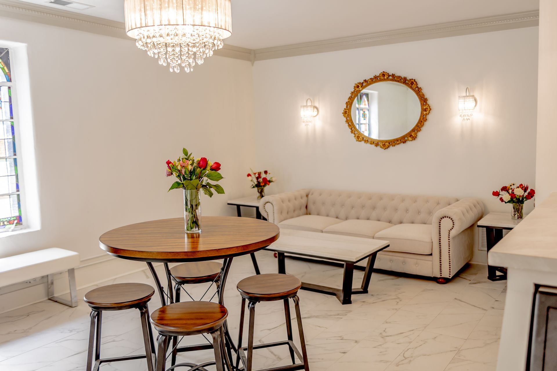 Modern conference room with wooden tables, grey chairs, and a small black smart speaker in the foreground.