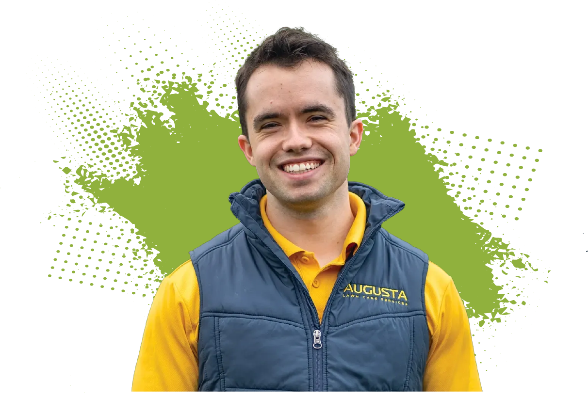 A man wearing a yellow augusta polo shirt points at something