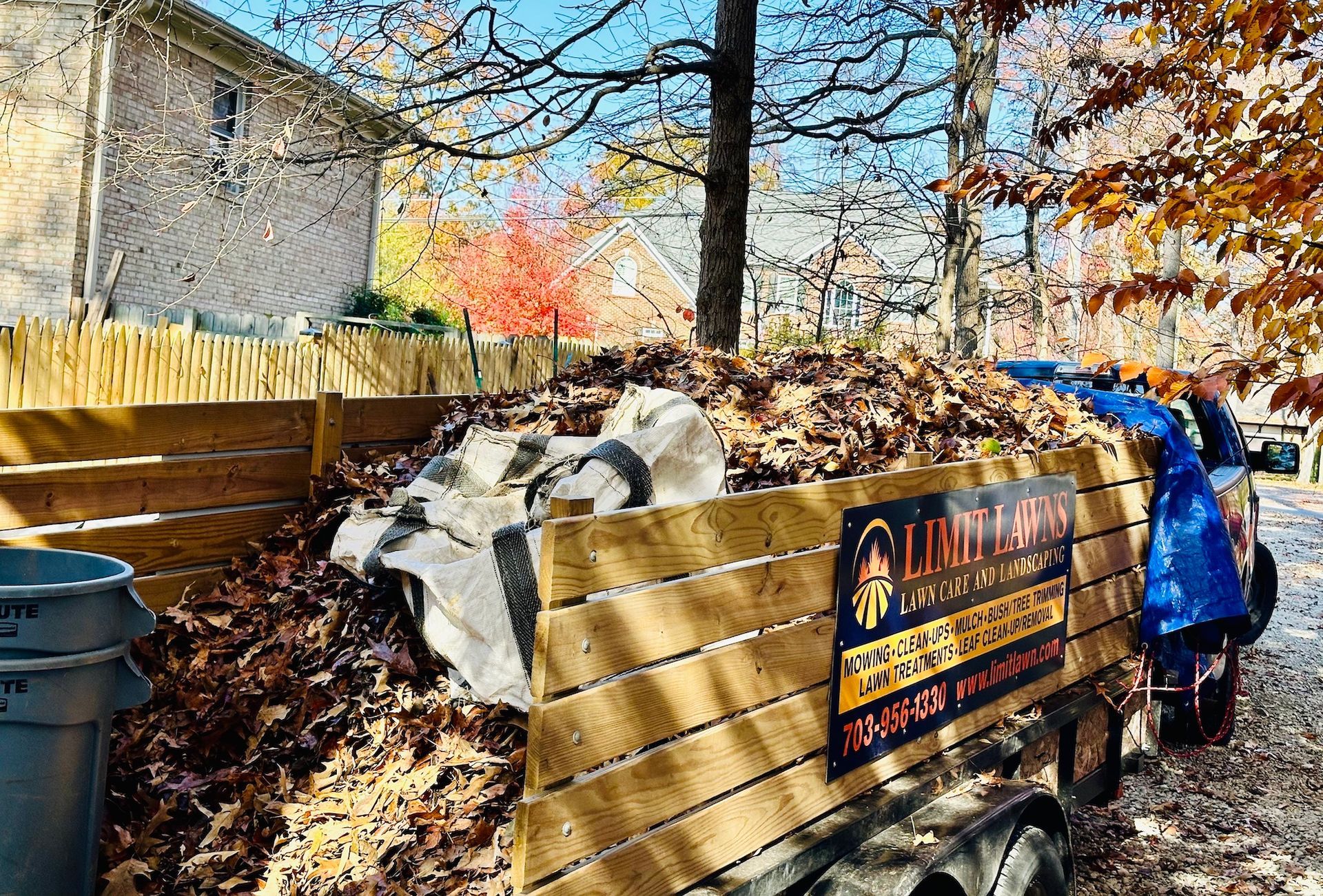 a person is loading leaves into a trailer .