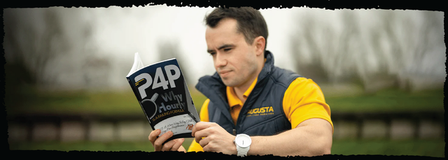 a man in a yellow shirt is reading a book titled 24p