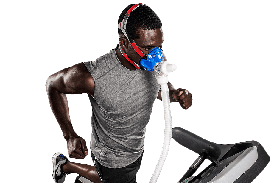 Man running on a treadmill wearing a blue oxygen mask.