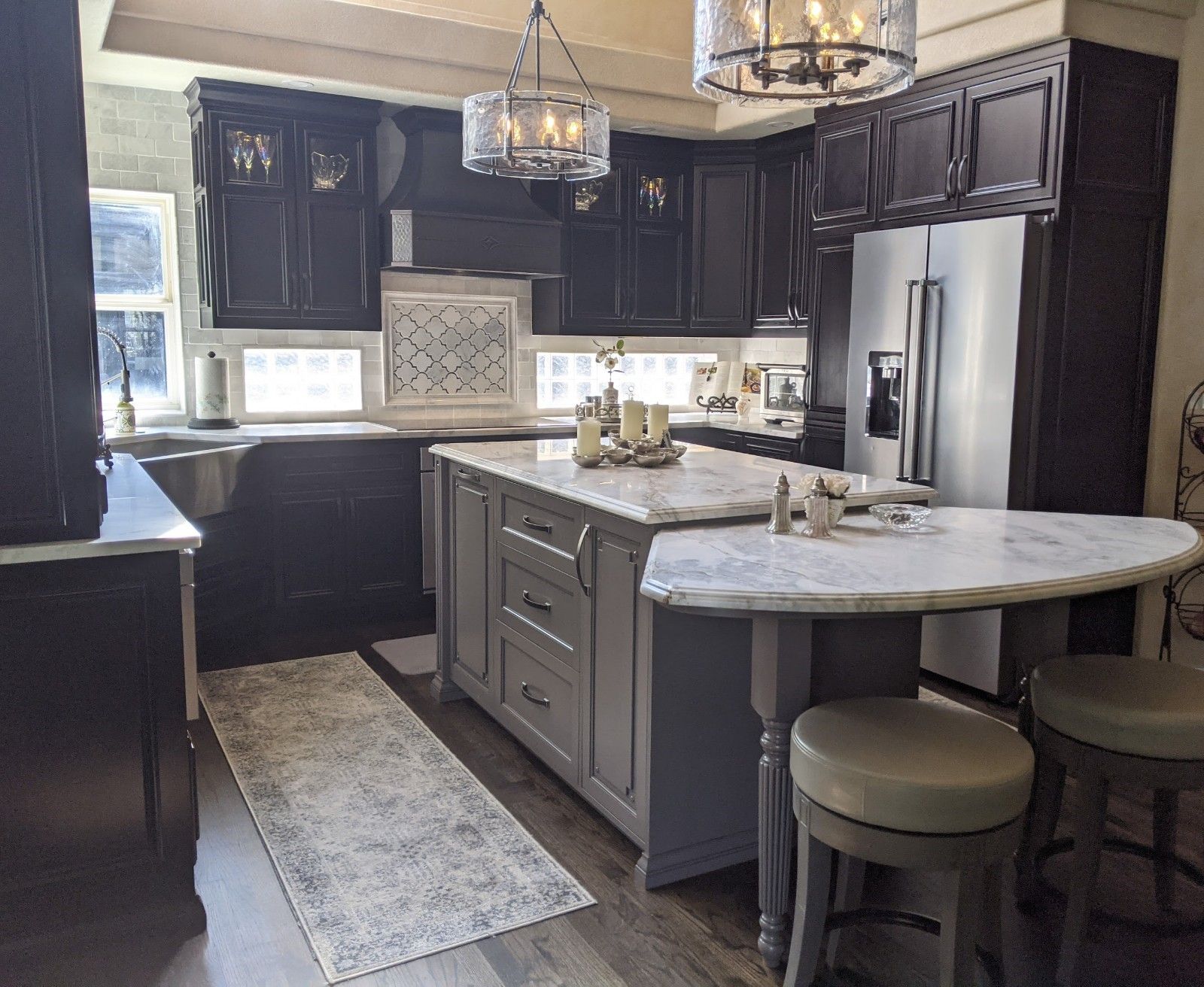 A kitchen with a large island and stools
