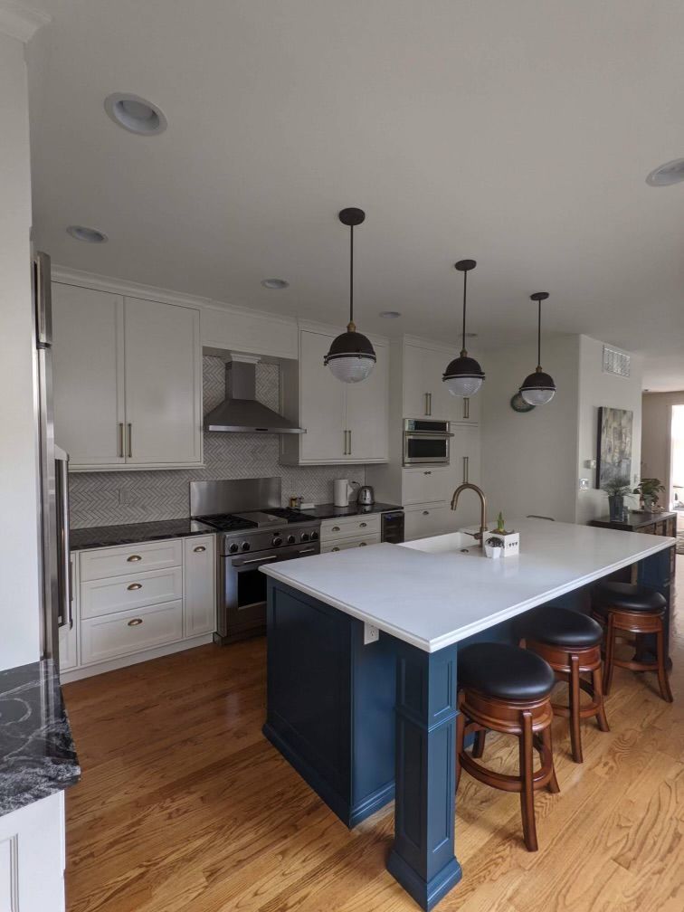 A kitchen with a large island and stools