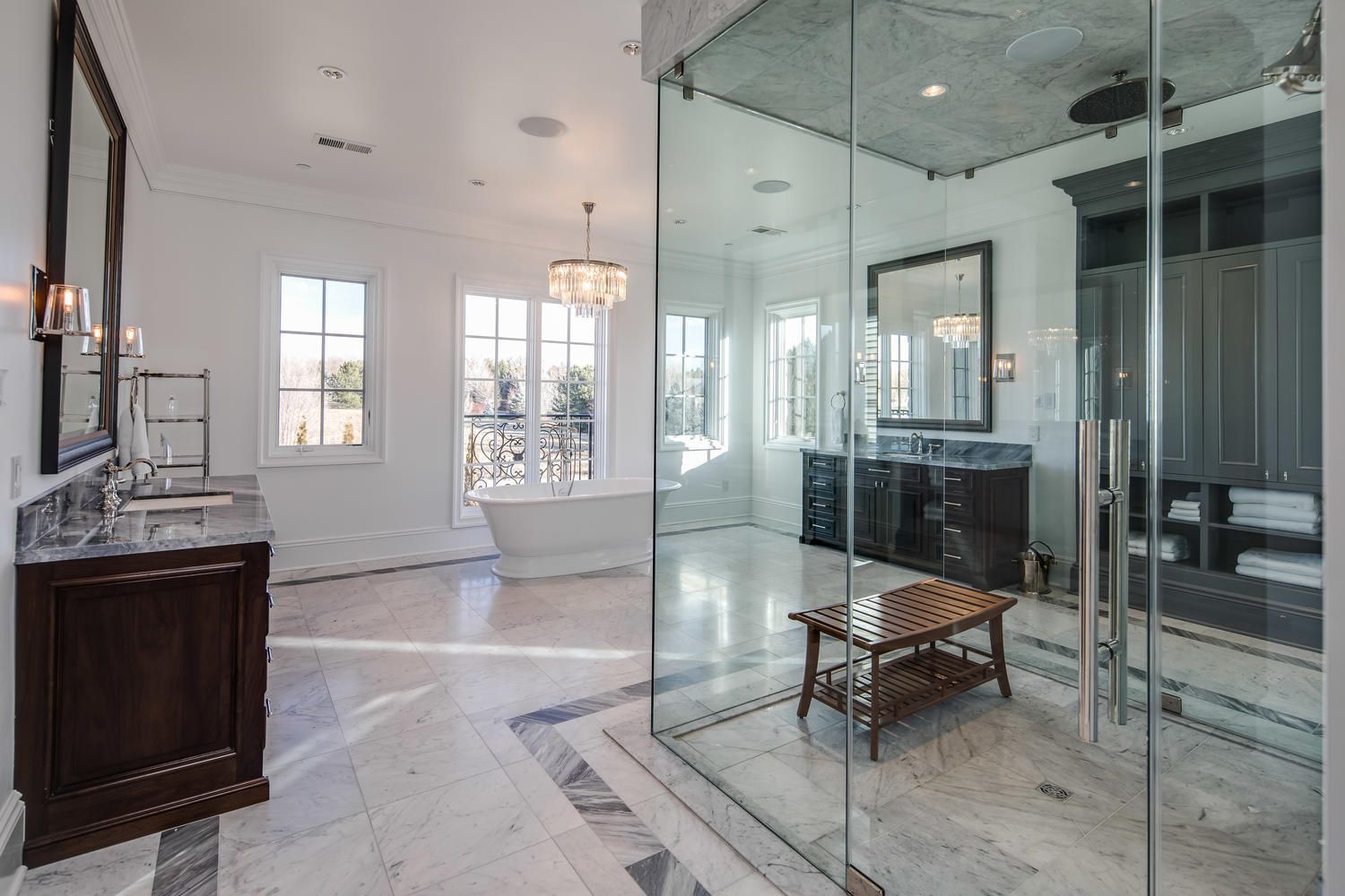 A bathroom with a walk in shower and a glass door.
