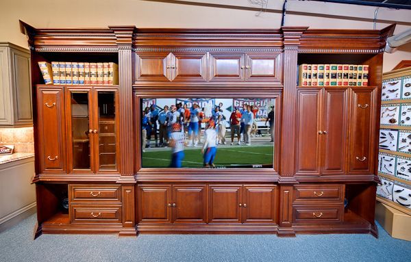 A large wooden entertainment center with a flat screen tv