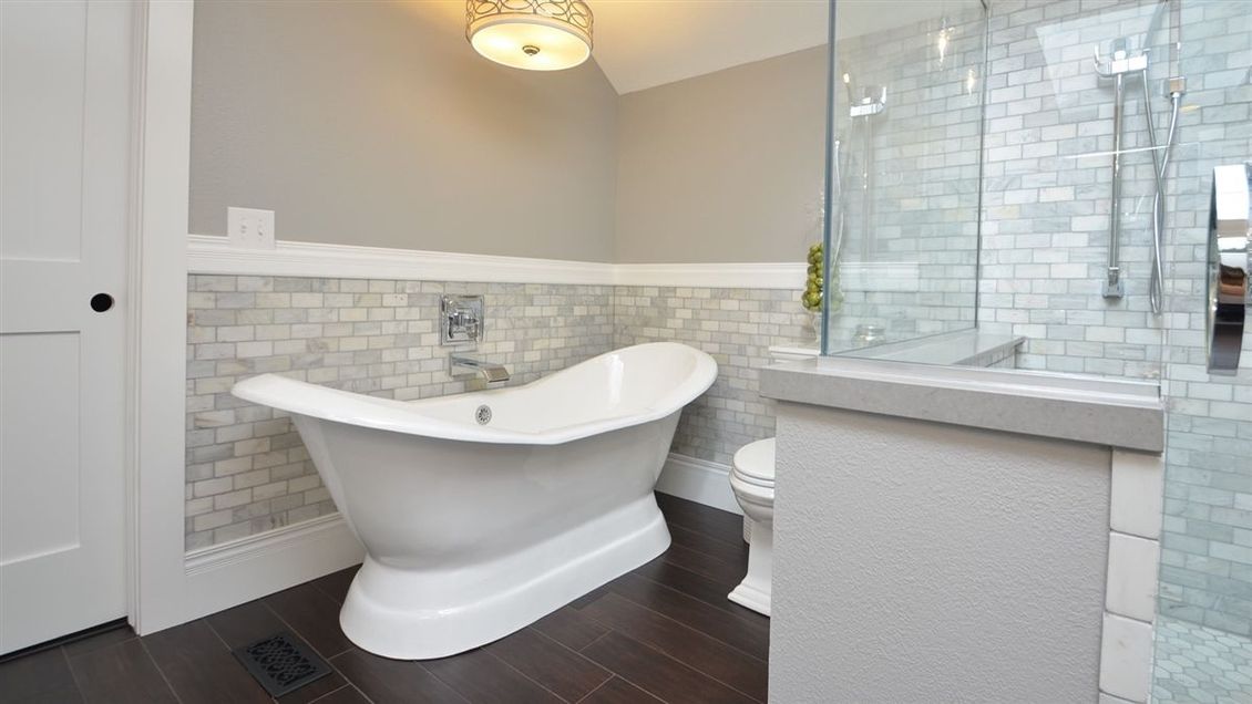 A bathroom with a bathtub , toilet , and shower.
