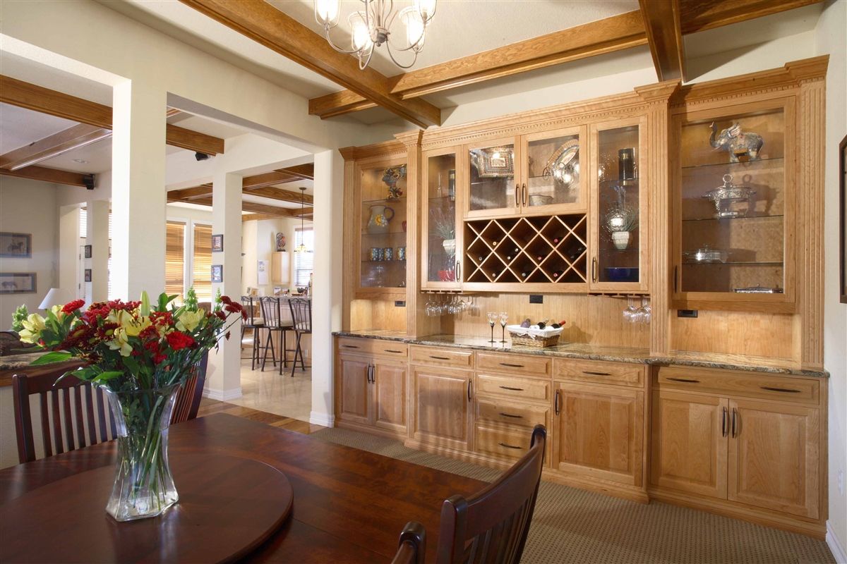 There is a vase of flowers on the table in the dining room.